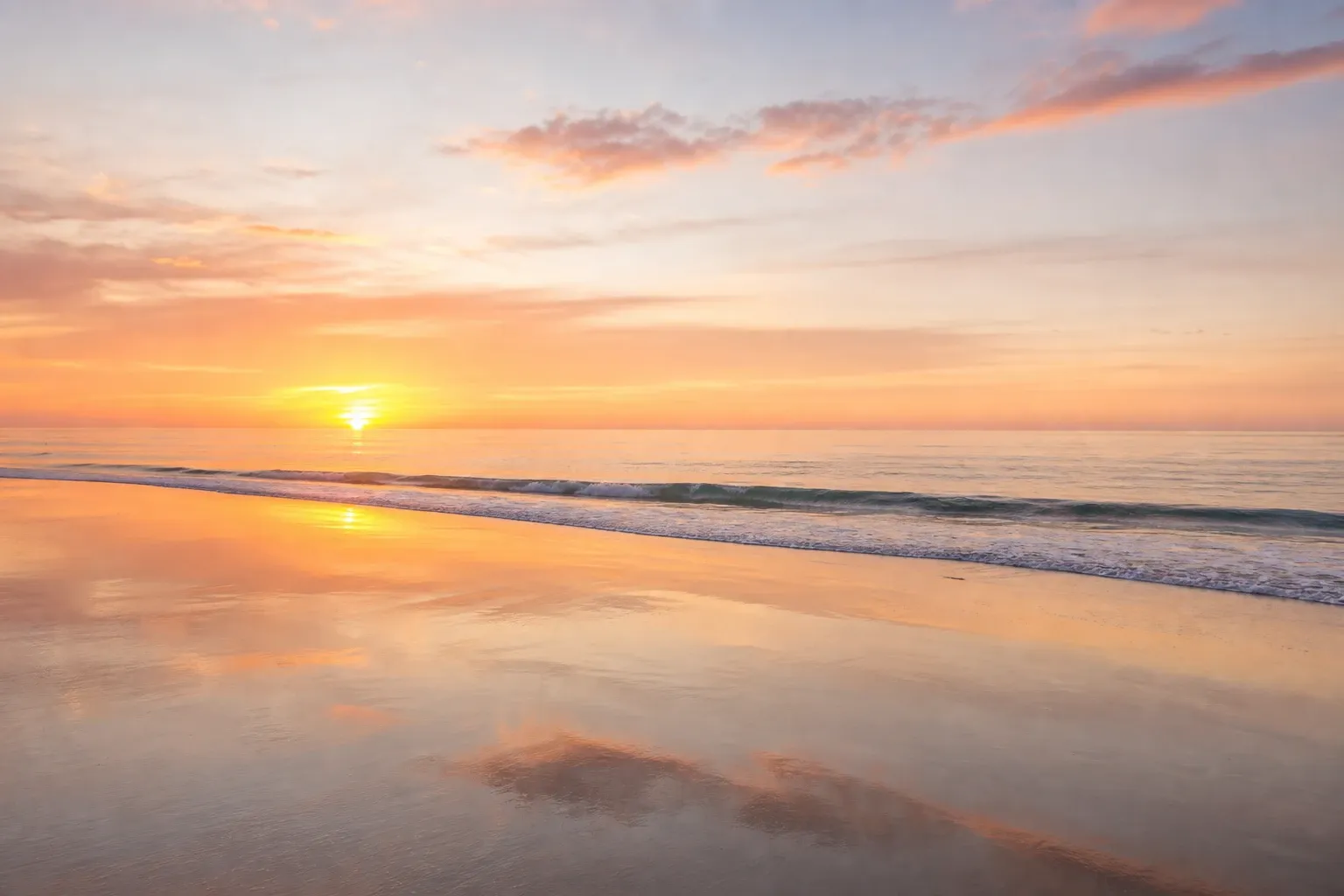Calm Pacific beach at sunrise with soft golden light