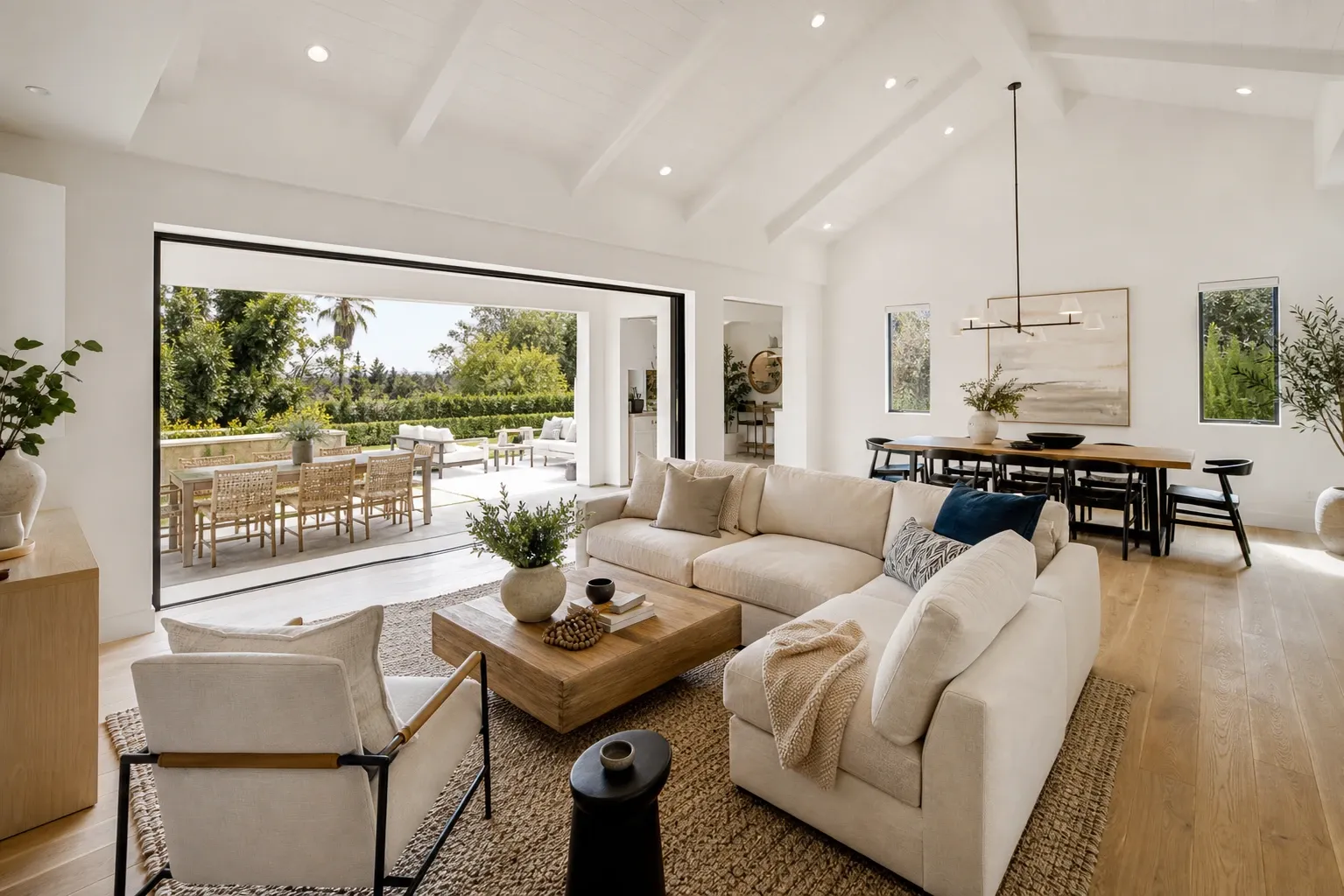 Open concept living room with vaulted ceilings and wood floors